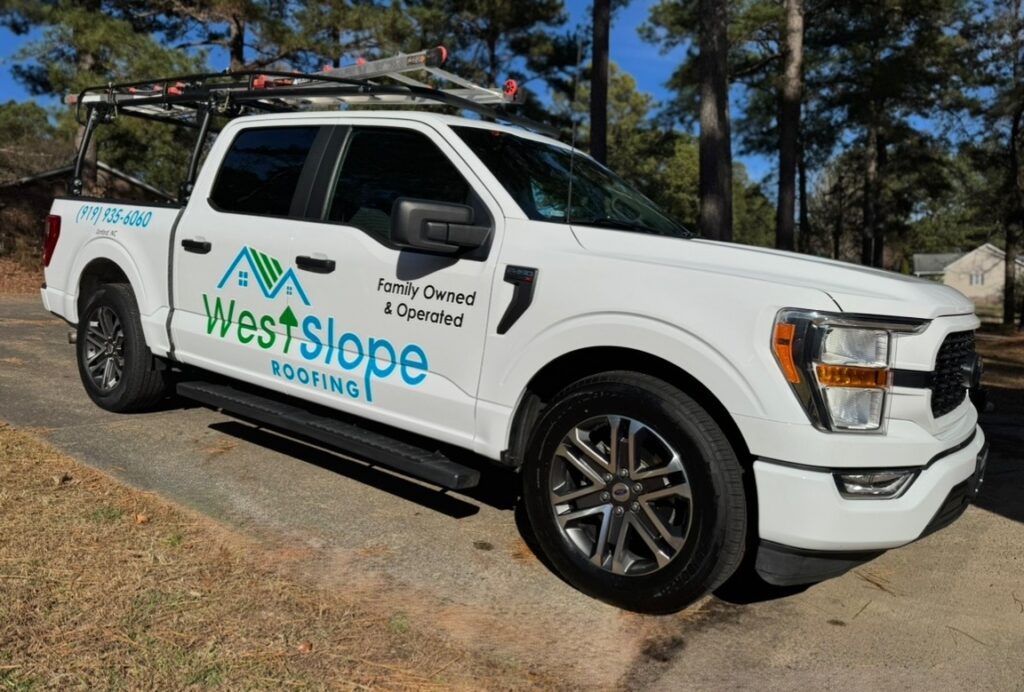 WestSlope Roofing service truck parked in a residential neighborhood, showing company branding and contact information.